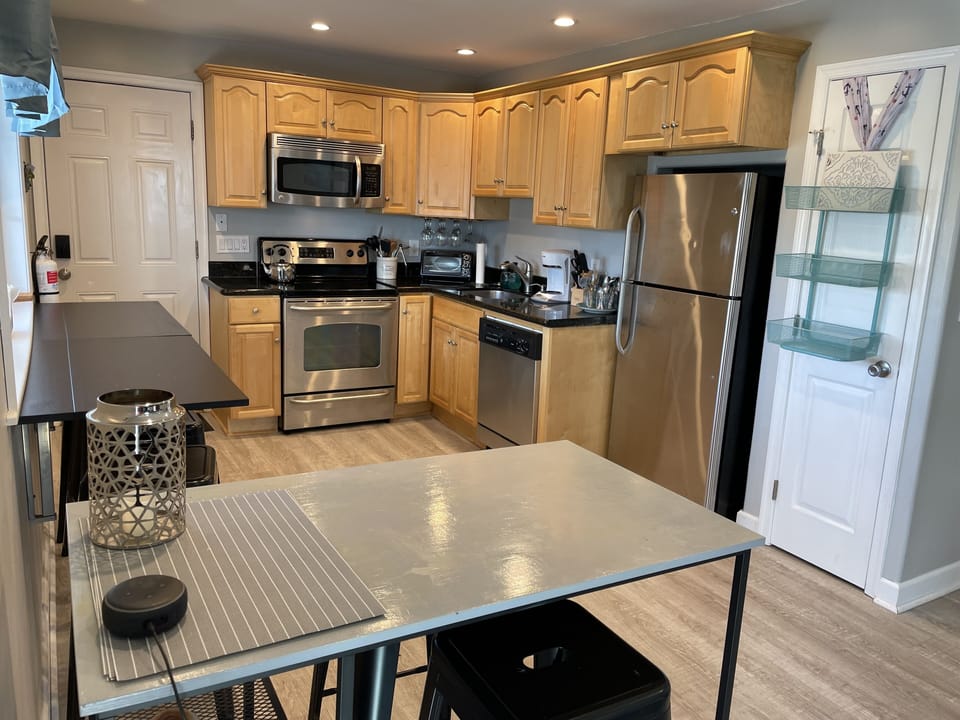 Open concept kitchen; granite, counter-height dining, fully stocked supplies.