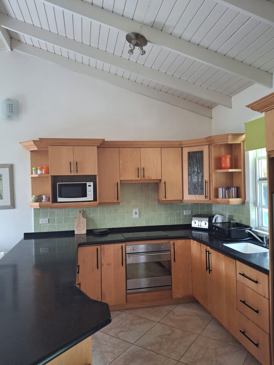 Fully fitted kitchen equipped with utensils for home cooking.