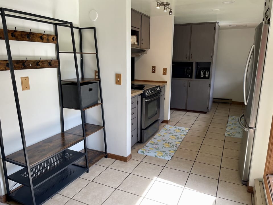 Fully furnished kitchen and back entryway 