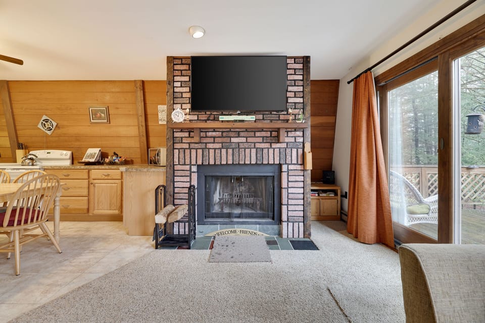 Cozy living room with lots of natural light and wood burning fireplace