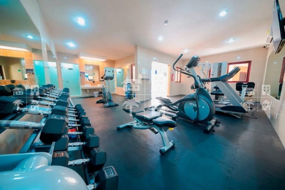 Fully equipped fitness center with cardio machines.