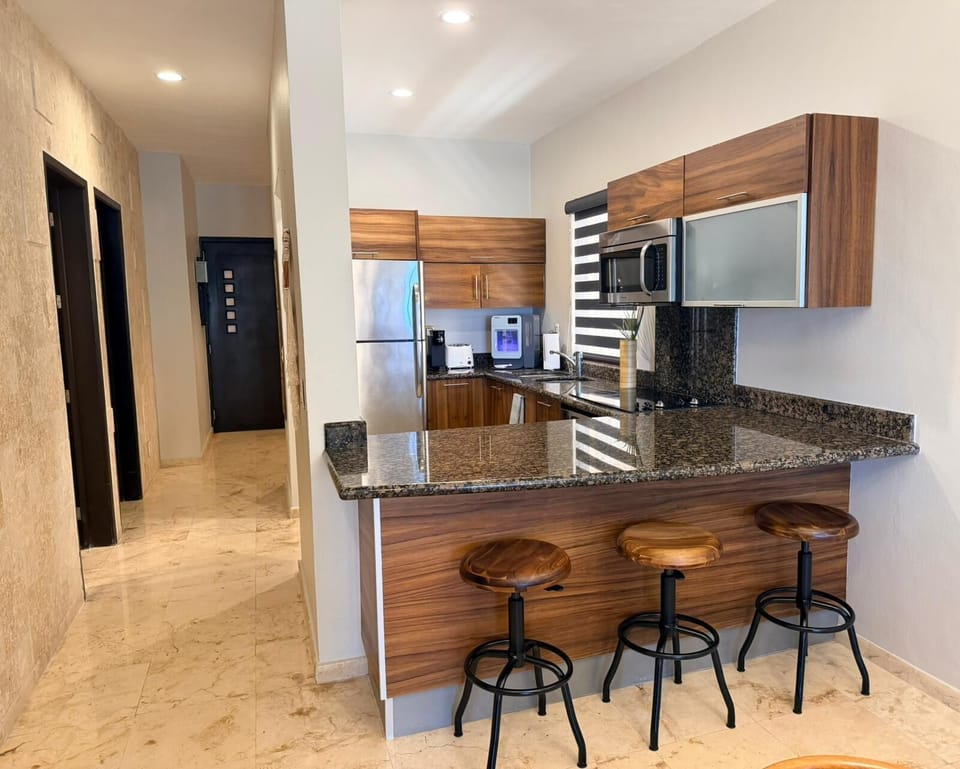 Sleek kitchen with breakfast bar seating.