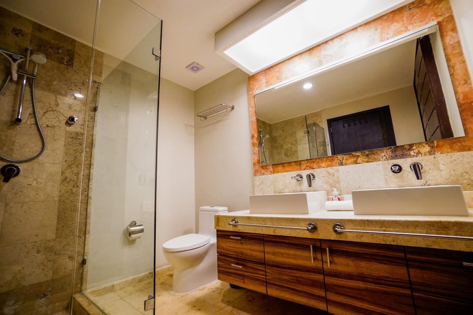 Spacious bathroom with double sinks and a shower.