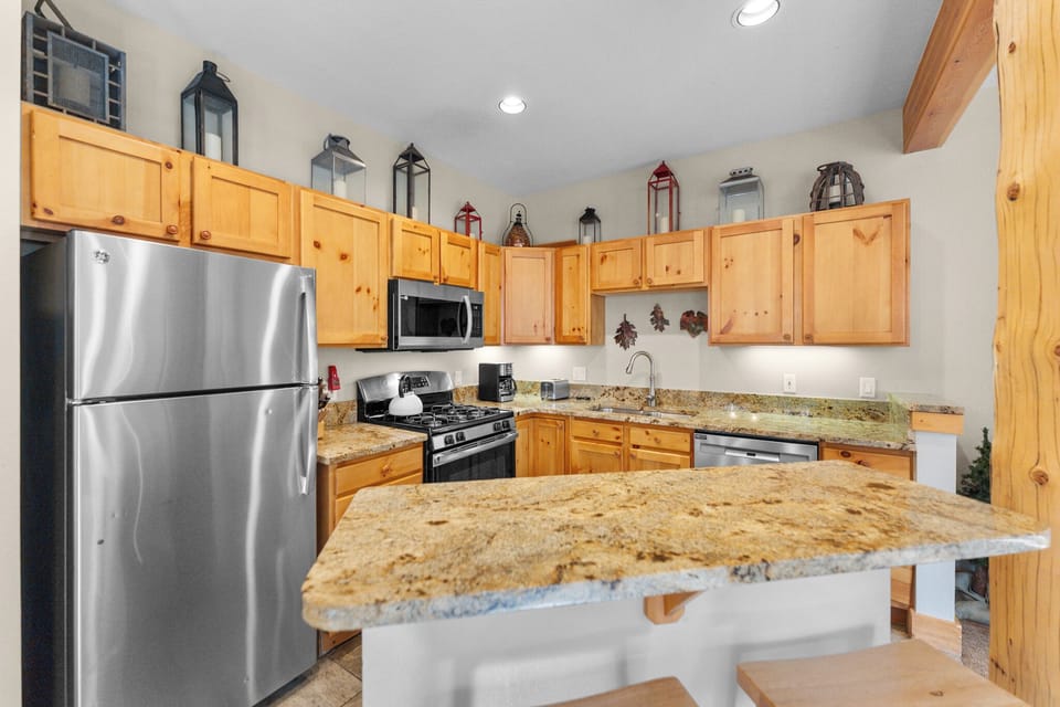 The kitchen features granite countertops and stainless steel appliances.