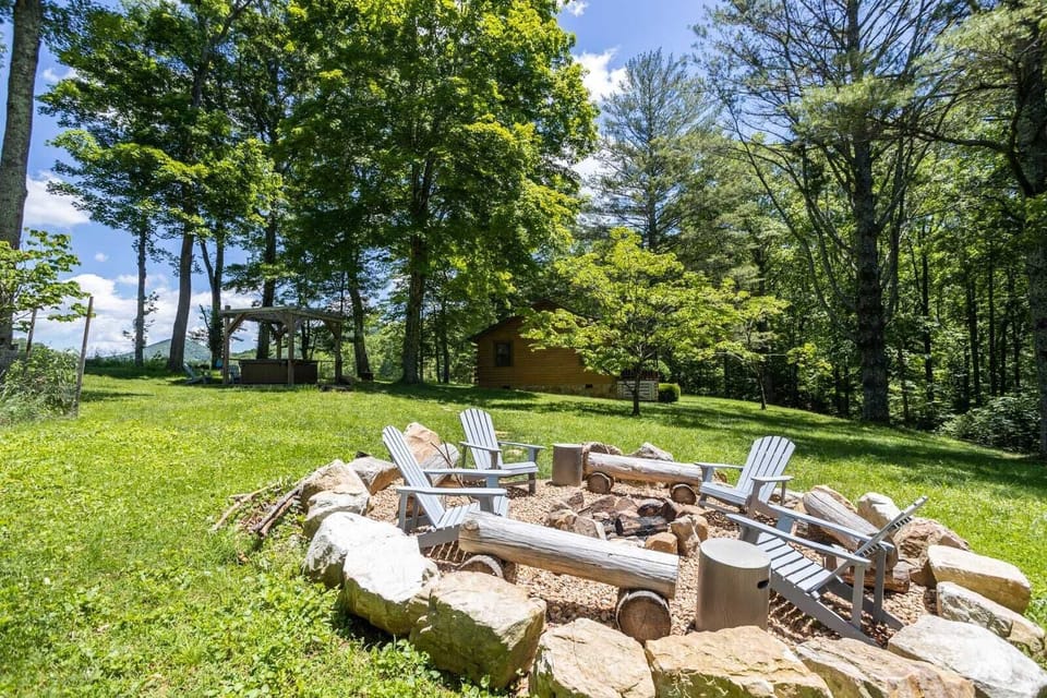 Fire Pit with Seating at the End of the Path Beyond the Hot Tub