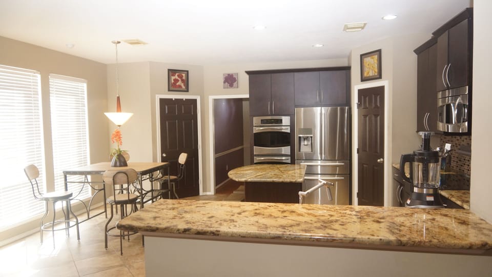 Fully equipped kitchen with full height cabinets, granite counter tops, fridge
