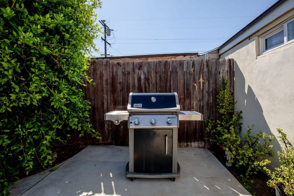 Backyard is fully fenced and private, Patio table & chairs, BBQ and additional seating in this sunny outdoor space.