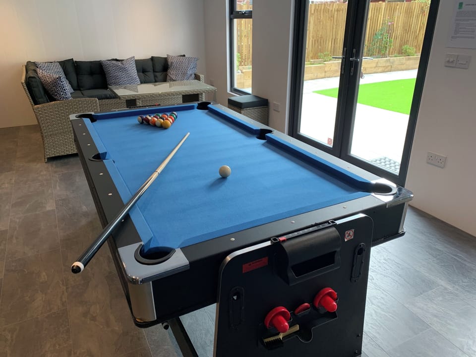 Pool table in the games cabin overlooking the back garden.