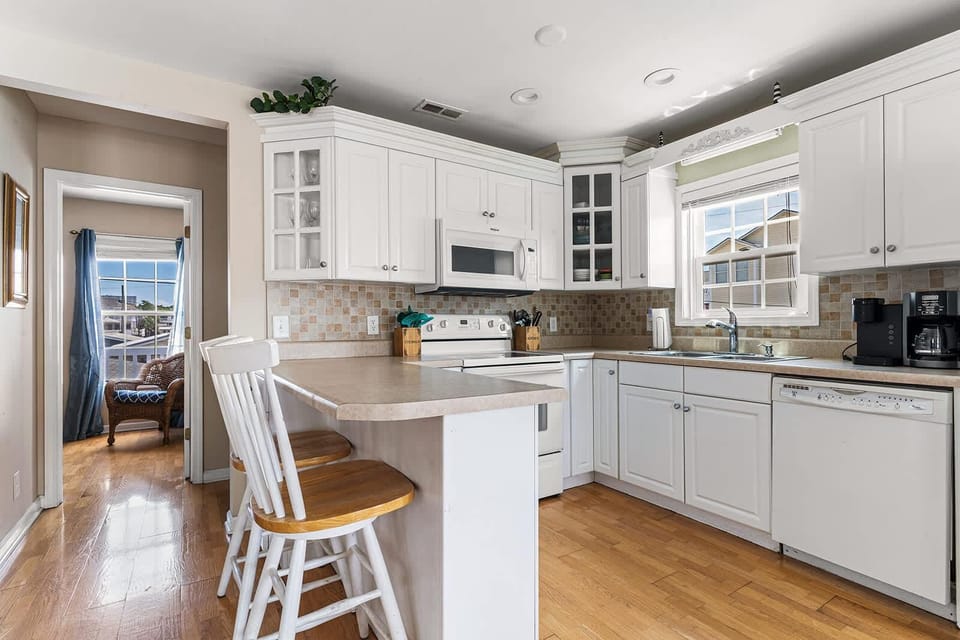 Bright, airy kitchen with cozy breakfast bar seating