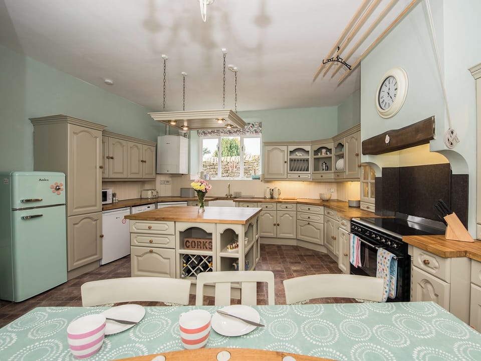Kitchen/diner with hand painted units and a fabulous range cooker | The Coach House, Fremington, near Richmond