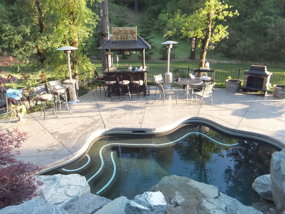 Pool and lawn area in the background.  