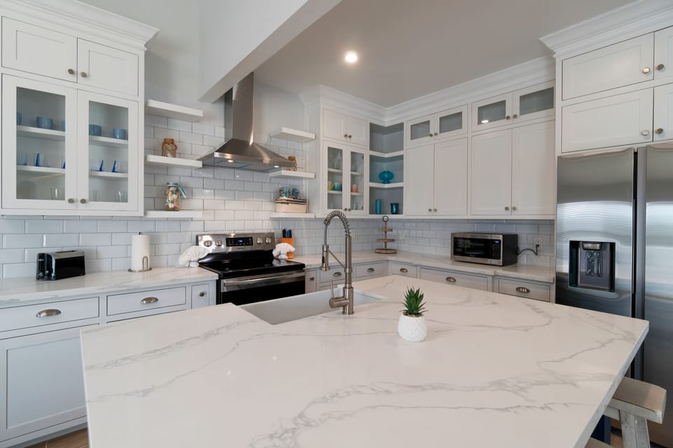 Modern kitchen with large center island and bar seating.