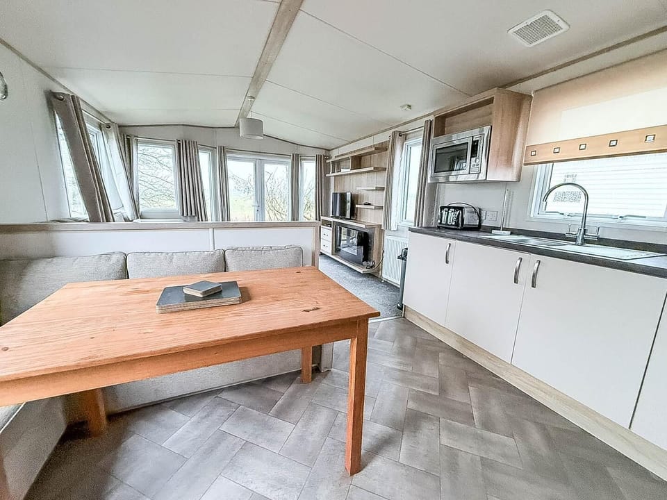 The living area in the caravan is perfect for enjoying meals together or watching a movie.