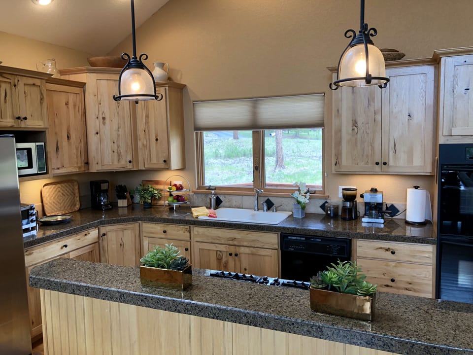 Fully-equipped kitchen open to the great room and the beautiful meadow view!