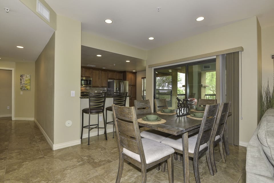 View of kitchen and two of three dining areas.