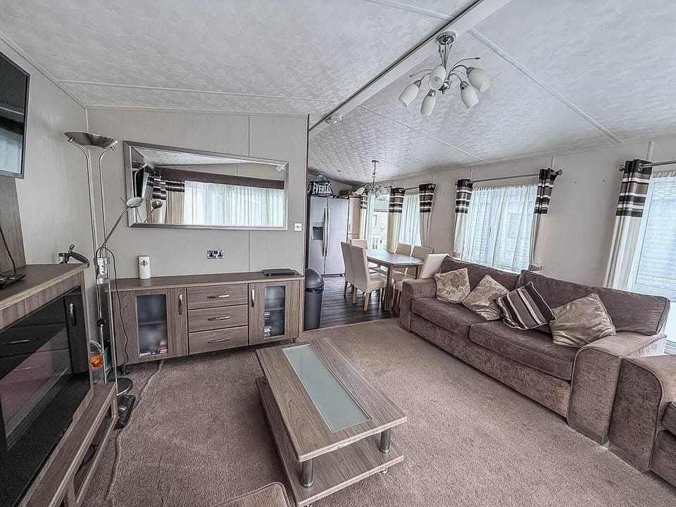 For last minute holidays UK, Park Holidays Broadland Sands offers a welcoming living room in a caravan, perfect for a family on holiday exploring the best of Great Yarmouth, Norfolk.