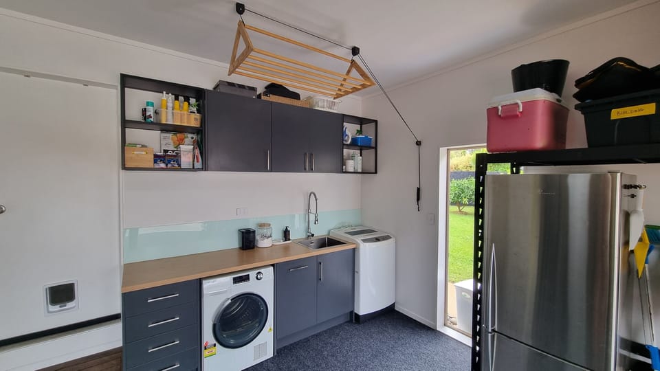 Laundry (in internal garage) with washer and dryer, and also a second fridge