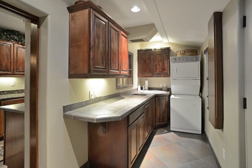 Laundryroom. Ironing Board on Right. Laundry Chute from Bedroom Left of Sink.