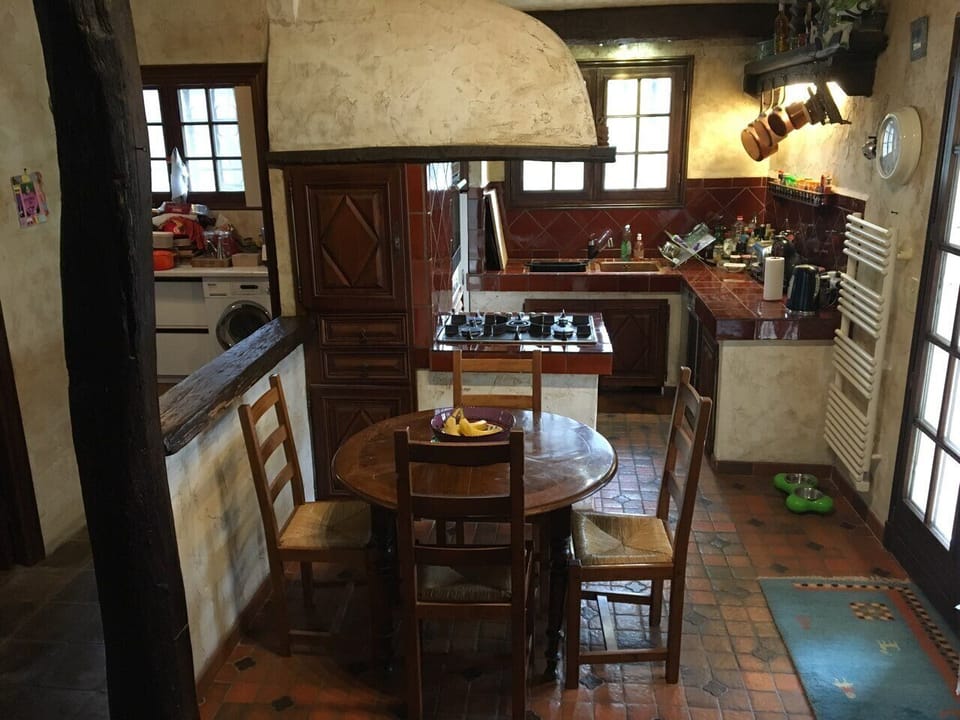 Kitchen area - dining table in front, kitchen area right, utility room left