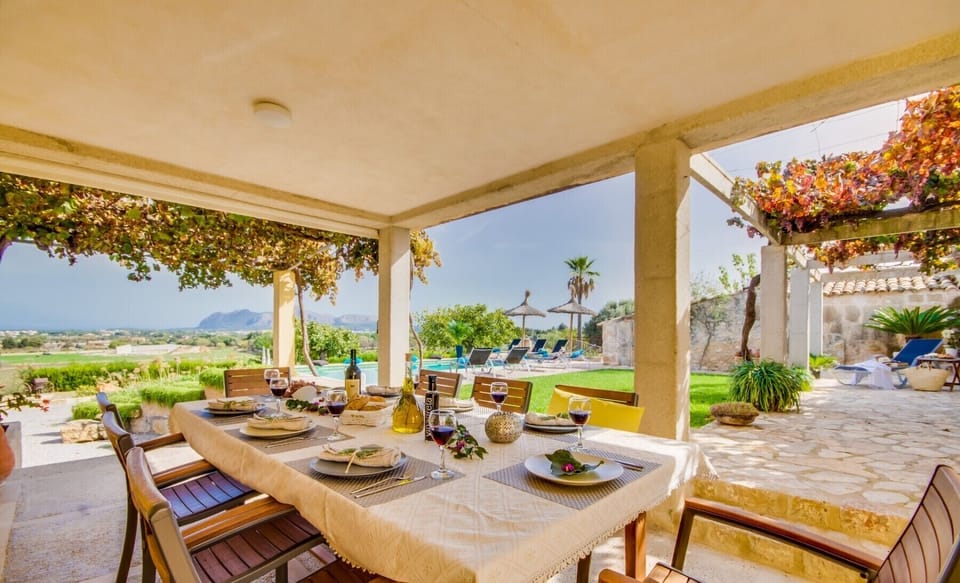 Beautiful terrace to enjoy the open-air meals protected from the sun with beautiful views to the sea and the Bay of Alcudia Finca Pegasus Alcudia Mallorca