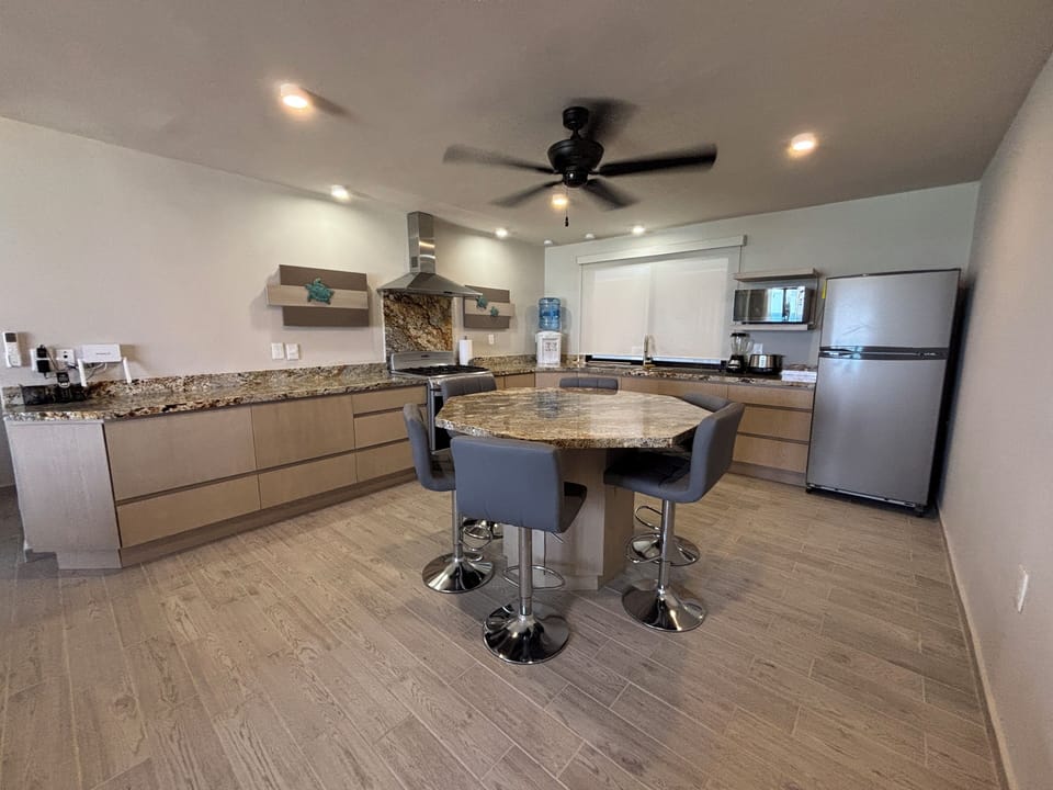 Kitchen area has ample counter space, small appliances and island seating for 6.
