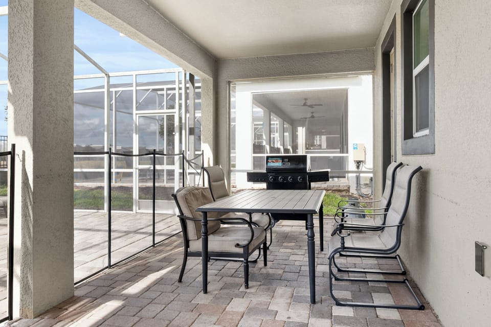 Your covered patio offers peaceful dining with a gas grill nearby for easy outdoor cooking.