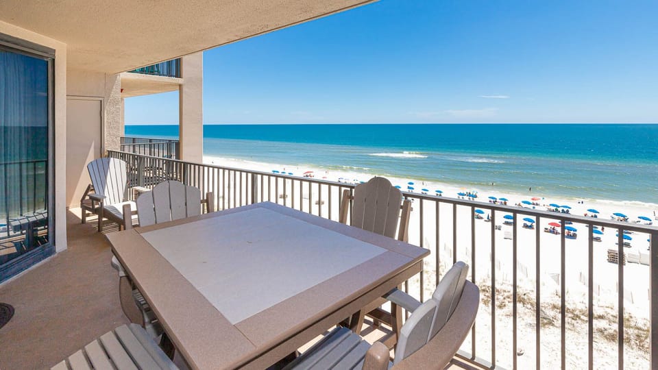 Enjoy meals or drinks at the outdoor balcony table while taking in the beautiful view of the beach and water