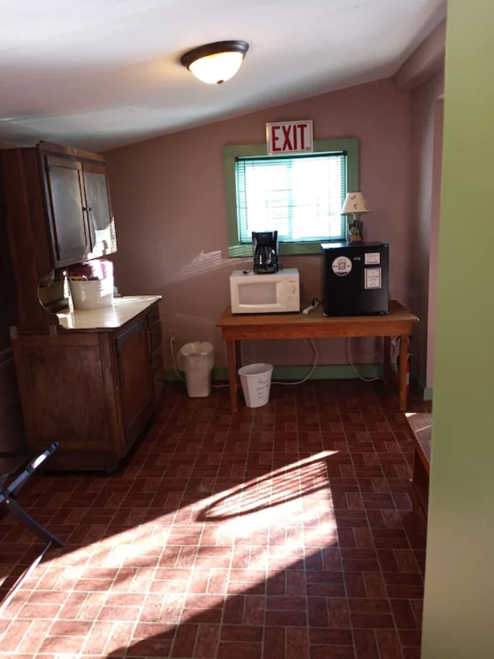 View of coffee pot, microwave, mini fridge
