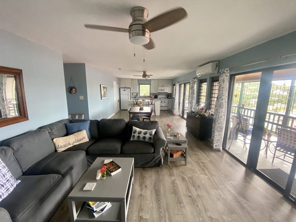 Living area with large sectional looking toward dining and kitchen areas