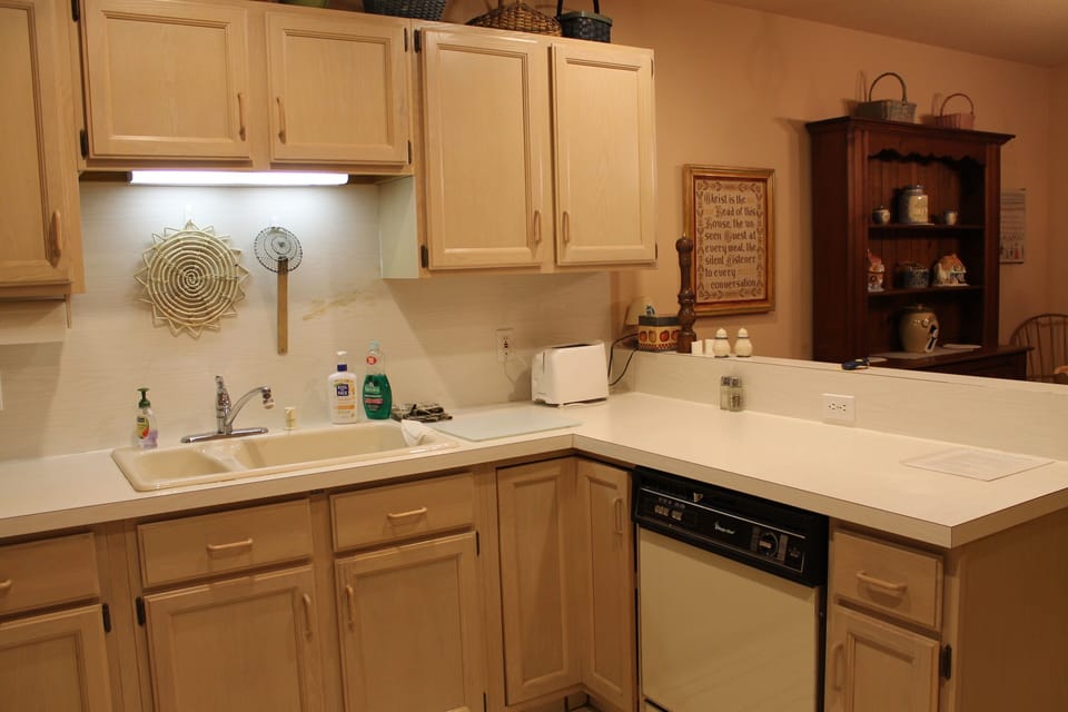 Kitchen complete with pots, pans, dishes, utensils, and appliances