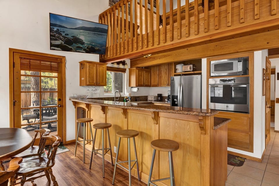 Fully equipped cabin kitchen with ample cabinetry, stove, fridge, microwave, and coffee maker—perfect for cooking meals, morning coffee, and feeling right at home on your stay.