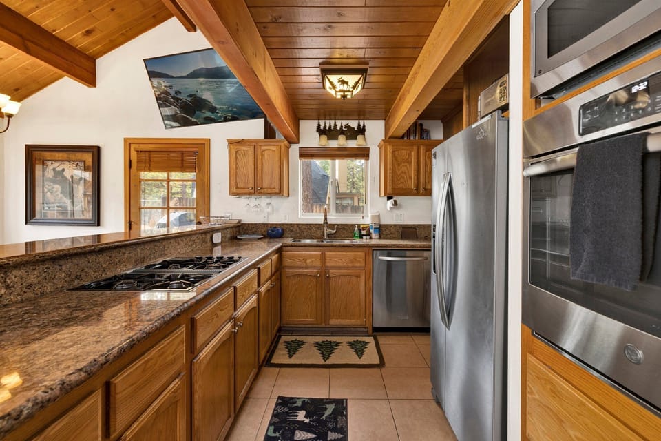 Fully equipped cabin kitchen with ample cabinetry, stove, fridge, microwave, and coffee maker—perfect for cooking meals, morning coffee, and feeling right at home on your stay.
