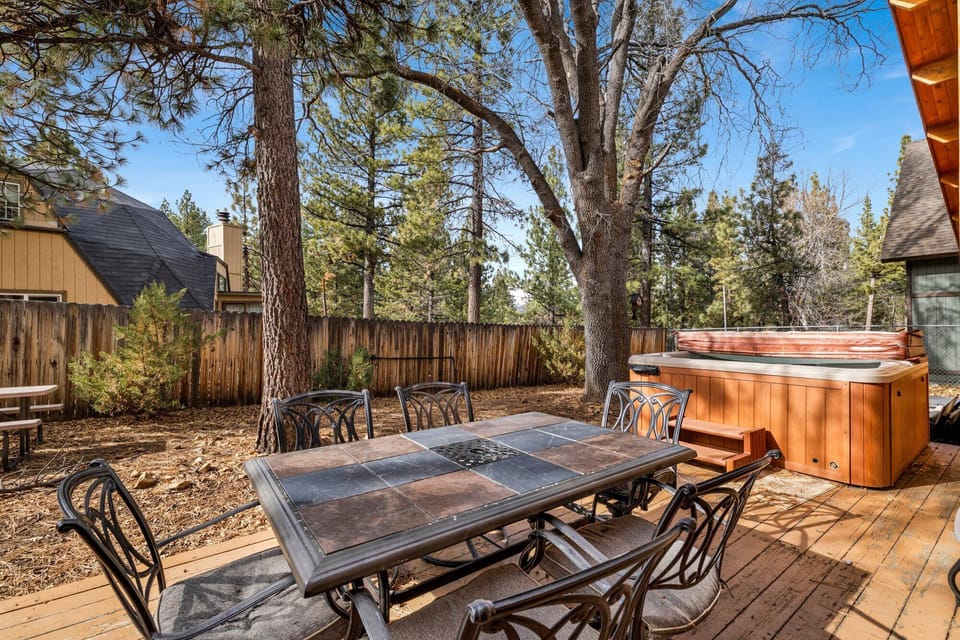 Private outdoor hot tub, surrounded by tall pines, perfect for relaxing under the trees after a day of adventure—enjoy peaceful forest views, fresh air, and a truly rejuvenating stay.