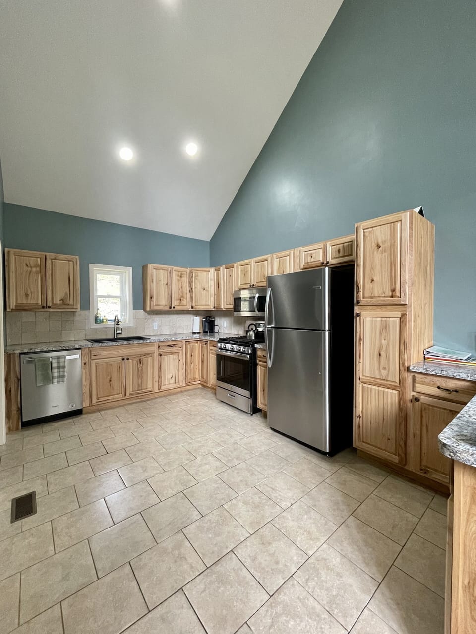 Large kitchen is fully stocked. Peninsula opens to dining room.