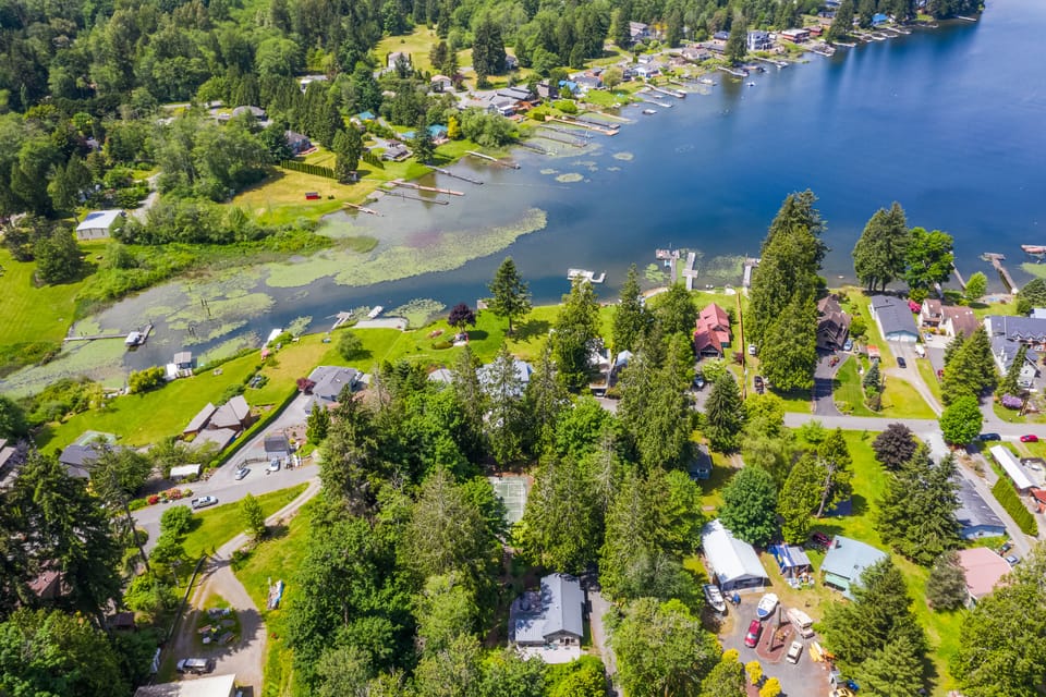 aerial view of cottage and lake