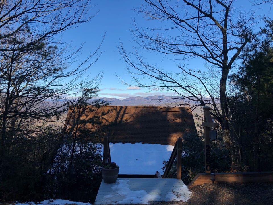 Stairs going into the cabin while standing in parking area. 