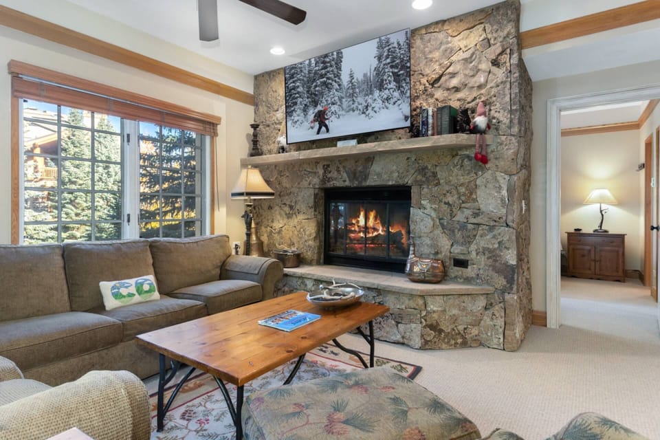 Living Room with Large Flat Screen Smart TV with Cable and Wood Burning Fireplace