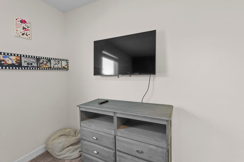 Unwind in your cozy entertainment corner with a large TV for movie nights and a comfy bean bag for ultimate relaxation.
