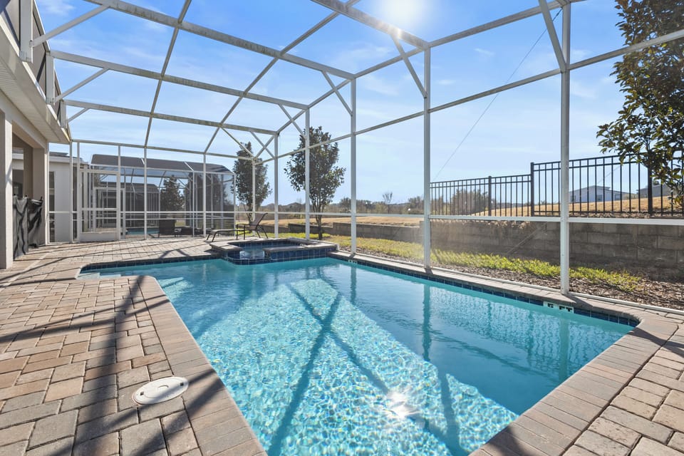 Your private pool oasis awaits with crystal-clear water and screened enclosure for comfortable swimming year-round.