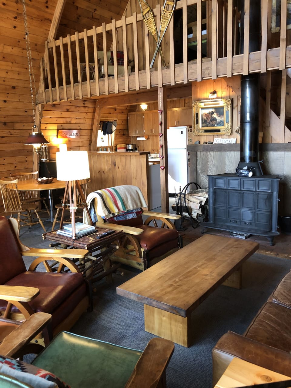 Main sitting area features a wood-burning stove and Spanish sunburst tiles