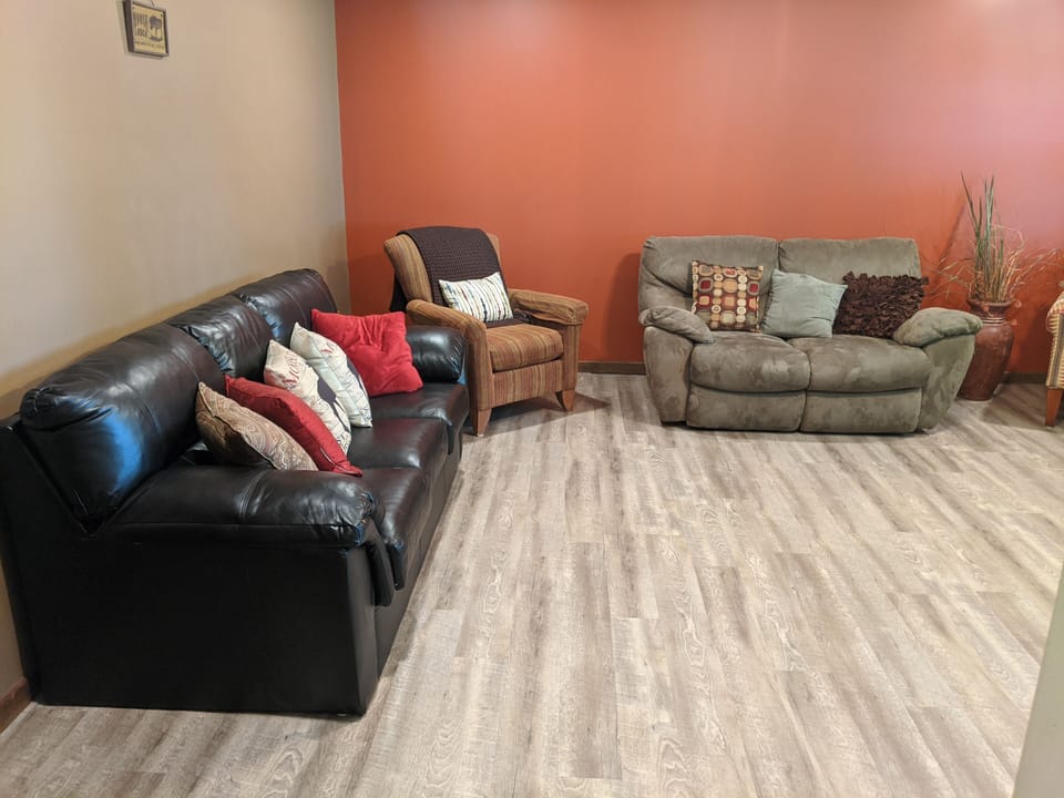 Front living room off kitchen with pull out sofa, reclining love seat, smart TV