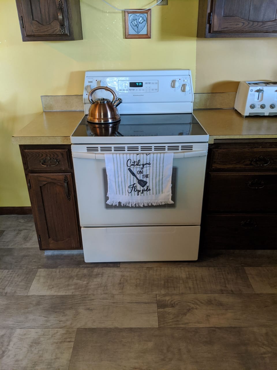 Big country kitchen with flat top stove, microwave, fridge/freezer, toaster