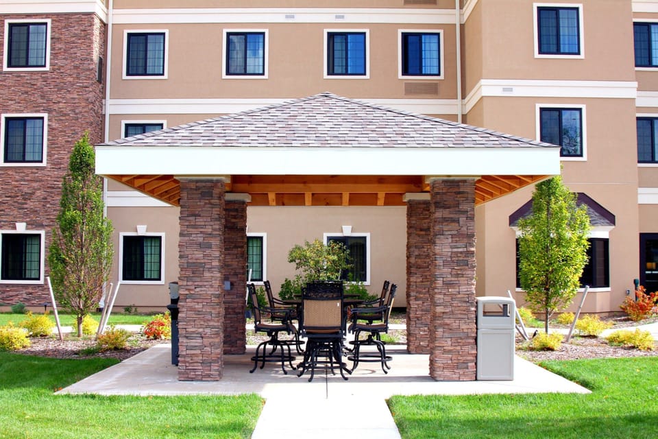 Covered outdoor patio with tables and chairs.