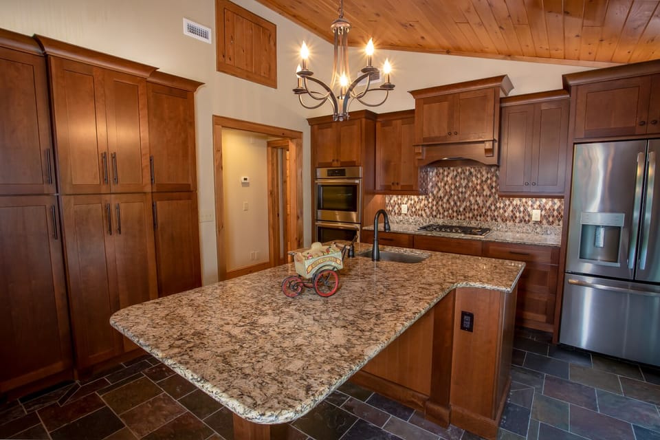 Central Granite Island has Bar Stool Seating and Second Sink