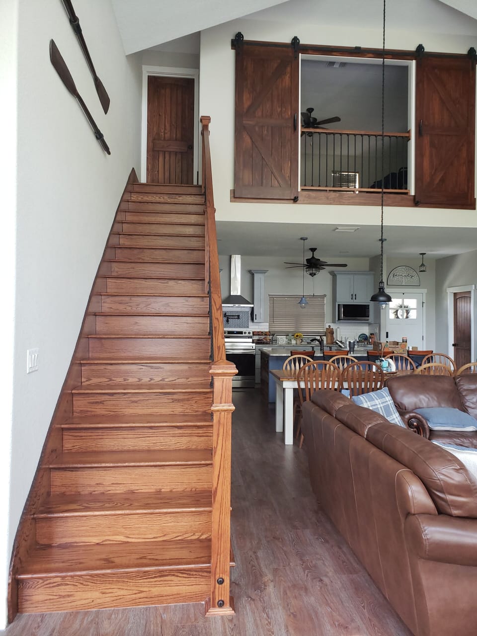 Beautiful natural wood staircase up to the loft.