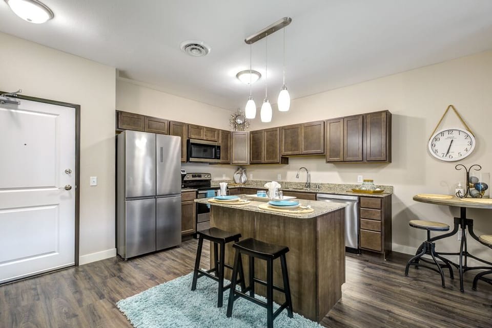 Full kitchen with stainless steel appliances and dishwasher.  Breakfast bar.