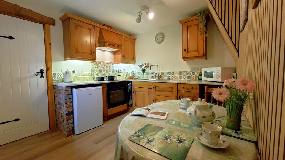 A fully equipped, good size kitchen with a  fan oven, hob & fridge