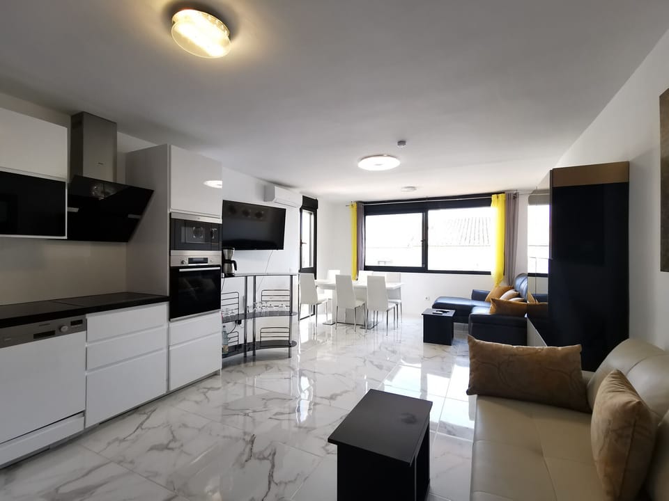 Large living/dining room with an open kitchen