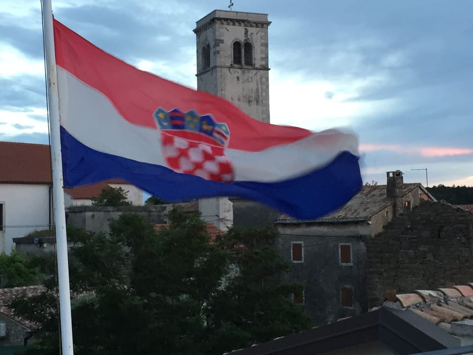 Church tower and Oprtalj rooftops from Tower Roof Terrace and the  Croatian flag