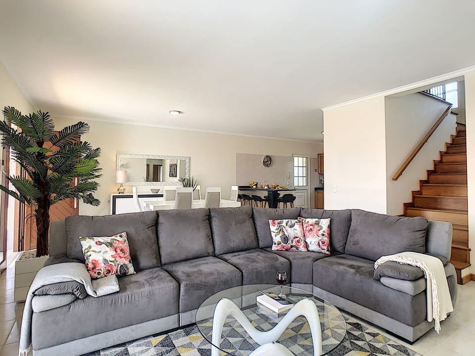 Capture the main floor perspective showcasing a spacious living room and inviting dining area. #sofa #diningarea #housedecordetails